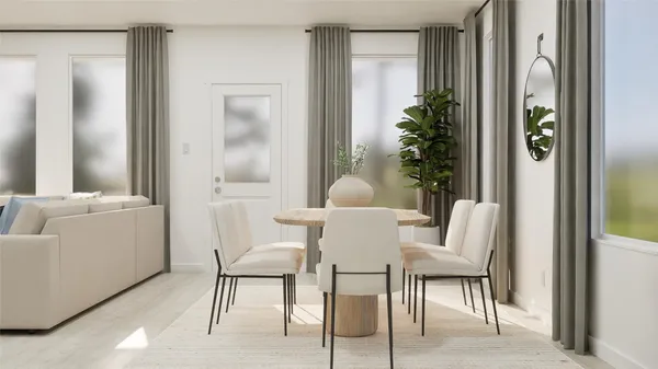 a view of a dining room with furniture and a potted plant