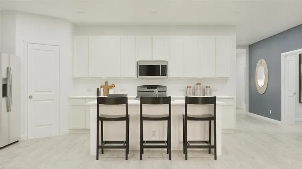 a kitchen with a table chairs and a refrigerator