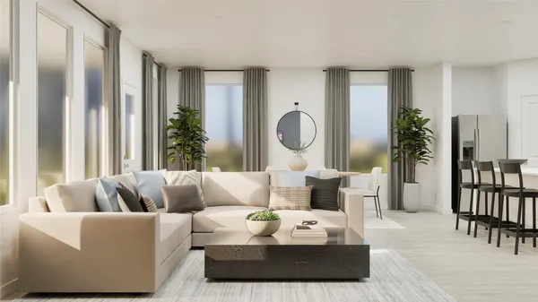 a living room with furniture fireplace and a large window