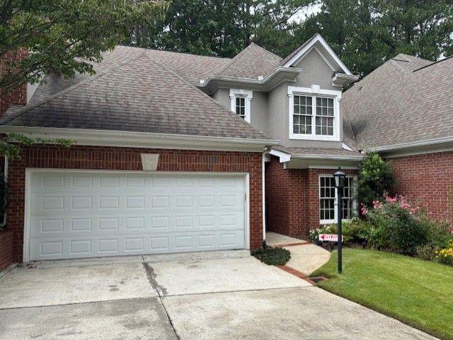 205 Crossing Valley Lane Atlanta, GA 30339 - Photo 1 of 1 a front view of a house with garden
