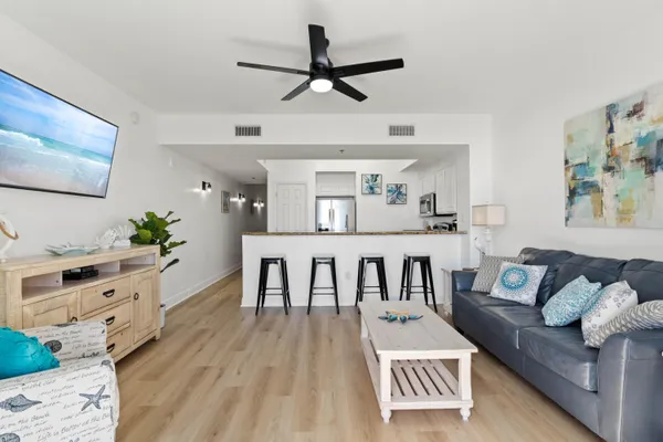 a living room with furniture and a wooden floor