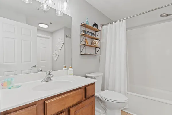 a bathroom with a sink vanity mirror and toilet