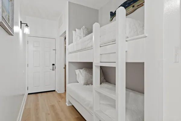 a bedroom with a bed and a white cabinet