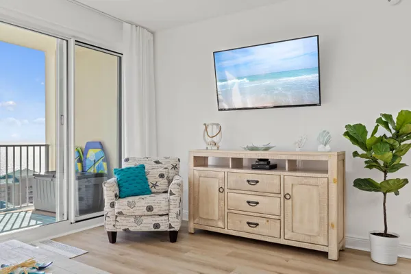 a living room with furniture and paintings on the wall