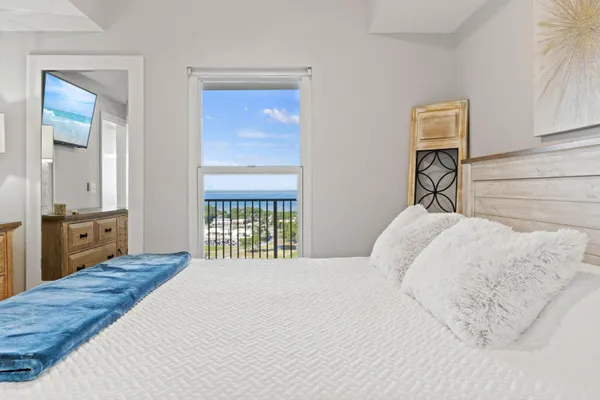 a bedroom with a bed and a closet with mirror