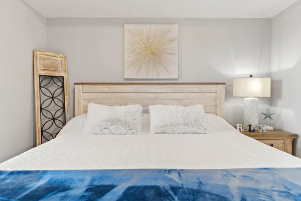 a bedroom with a bed and a night stand