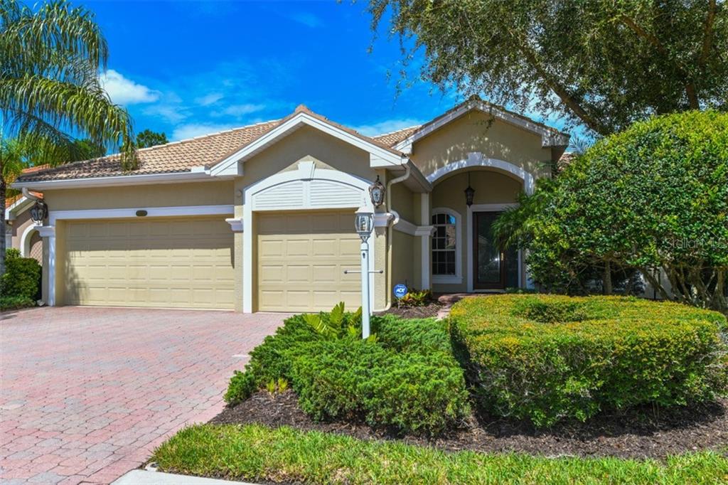 7747 US Open Loop Lakewood Ranch, FL 34202 - Photo 1 of 1 a front view of a house with garden