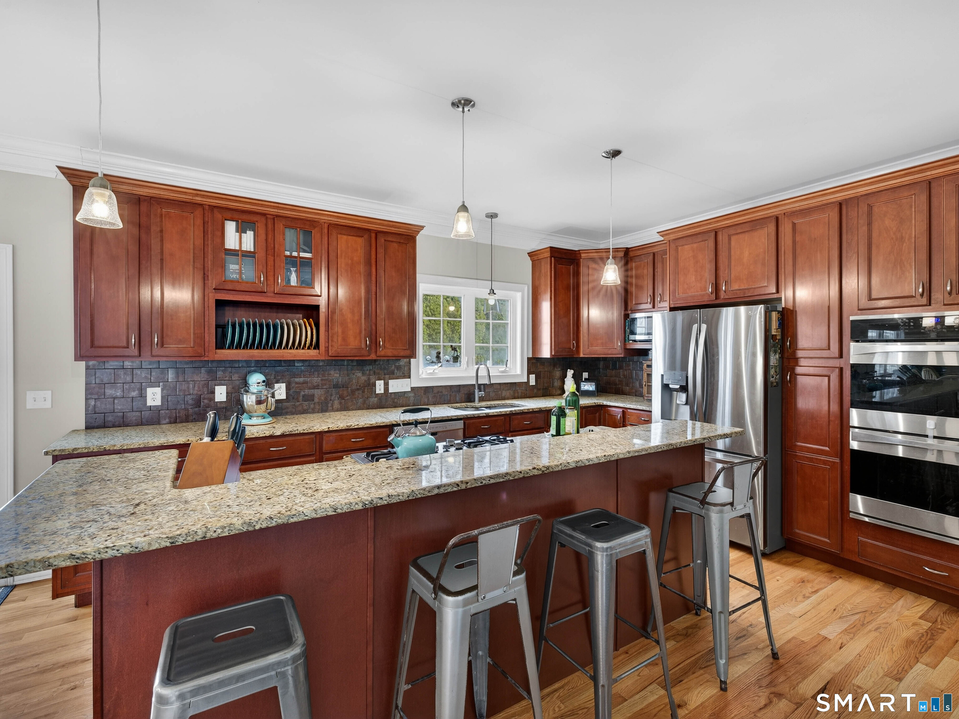 6 Constance Street New Haven, CT 06512 - Photo 16 of 39 a kitchen with stainless steel appliances granite countertop a sink a stove a refrigerator cabinets and chairs
