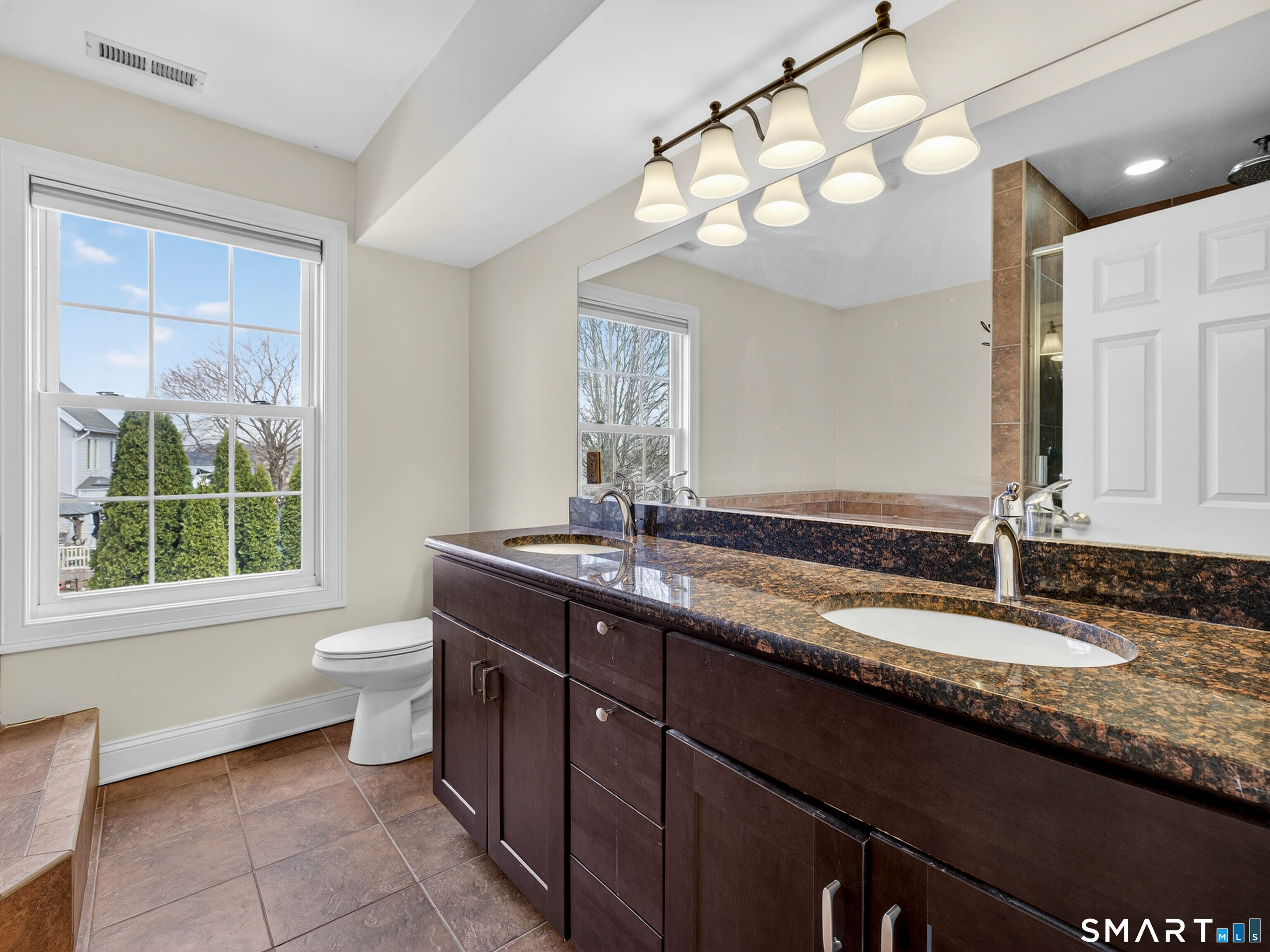 6 Constance Street New Haven, CT 06512 - Photo 21 of 39 a bathroom with a granite countertop sink a toilet and a mirror