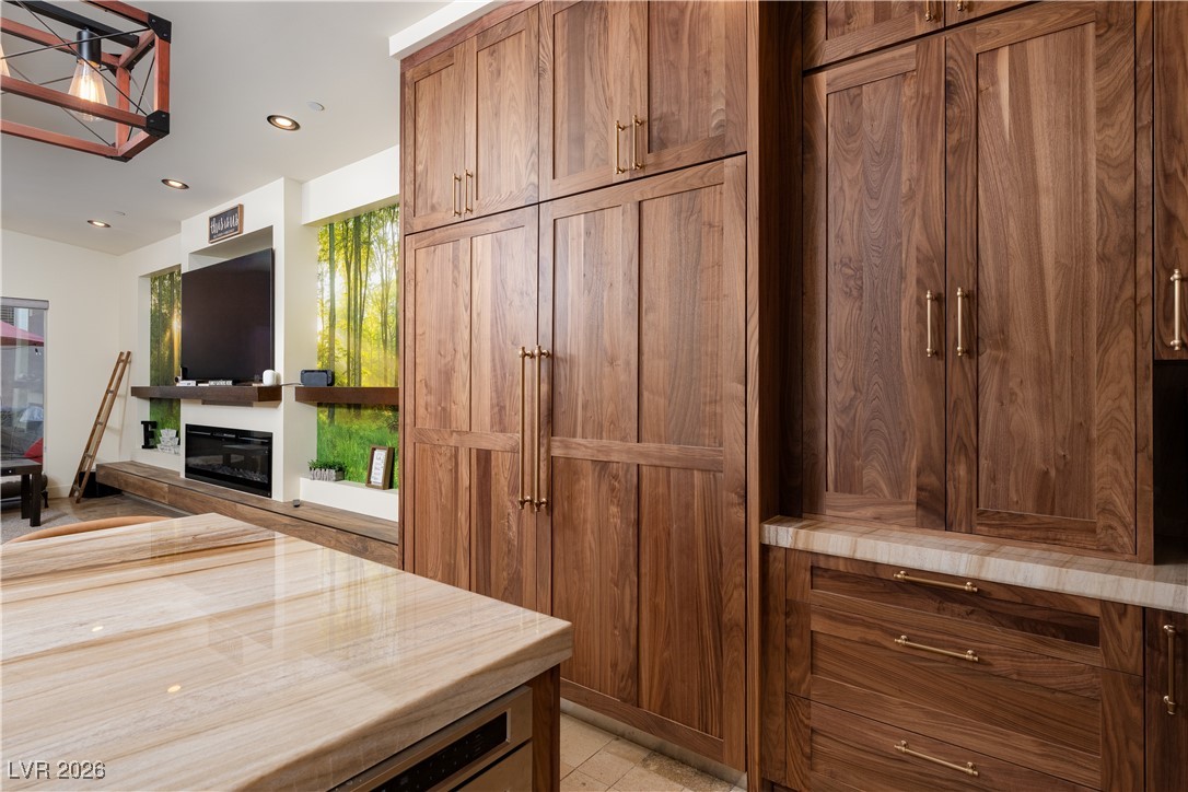 2817 High View Drive Henderson, NV 89014 - Photo 21 of 77 Kitchen with brown cabinets, recessed lighting, butcher block counters, and a glass covered fireplace