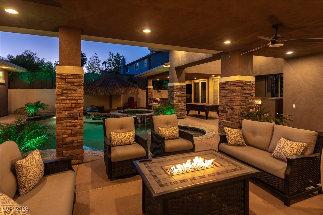 2817 High View Drive Henderson, NV 89014 - Photo 35 of 77 Patio terrace at dusk featuring ceiling fan, a patio, and an outdoor living space with a fire pit