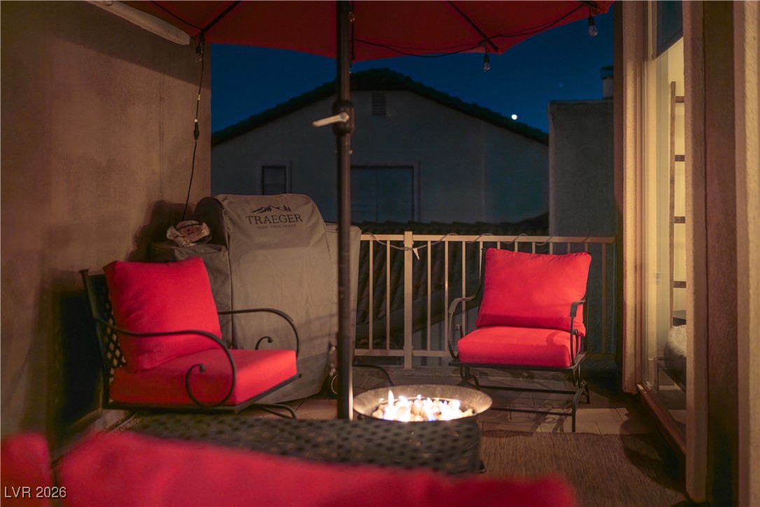 2817 High View Drive Henderson, NV 89014 - Photo 36 of 77 Patio at twilight with a balcony and an outdoor fire pit