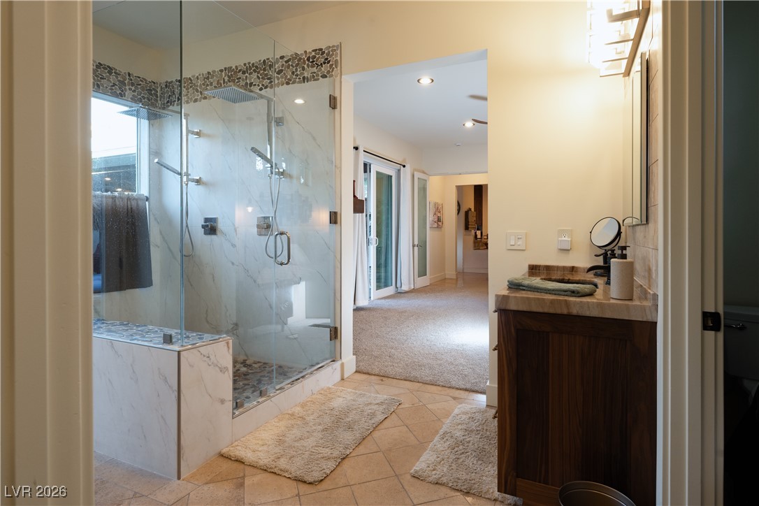 2817 High View Drive Henderson, NV 89014 - Photo 40 of 77 Full bathroom featuring vanity, a marble finish shower, light tile patterned flooring, light carpet, and recessed lighting