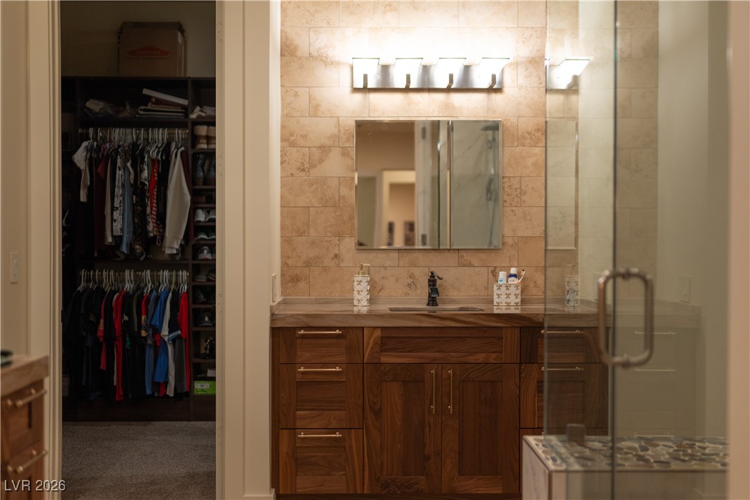 2817 High View Drive Henderson, NV 89014 - Photo 43 of 77 Bathroom with vanity, a spacious closet, and a shower stall