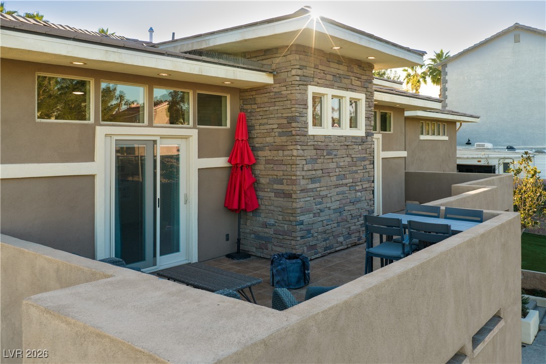 2817 High View Drive Henderson, NV 89014 - Photo 56 of 77 Back of property with stone siding, a patio, and stucco siding