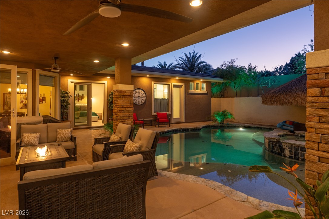 2817 High View Drive Henderson, NV 89014 - Photo 59 of 77 View of pool with an outdoor living space with a fire pit, a patio area, a fenced backyard, and a pool with connected hot tub