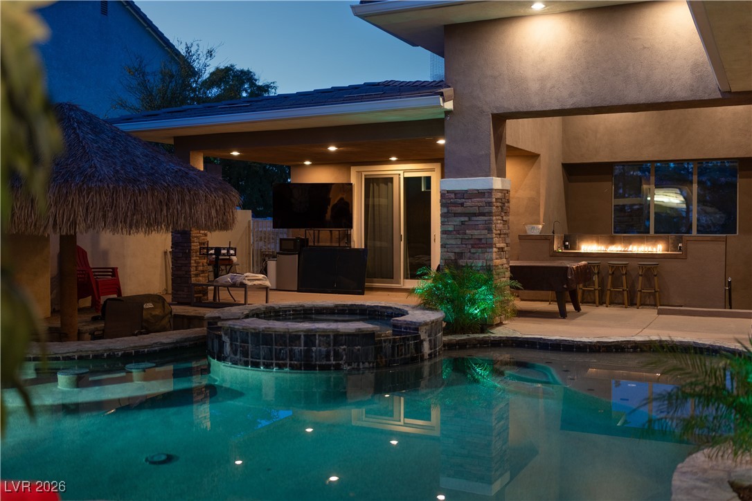 2817 High View Drive Henderson, NV 89014 - Photo 66 of 77 View of swimming pool with a patio, a pool with connected hot tub, and exterior kitchen
