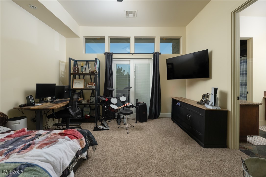 2817 High View Drive Henderson, NV 89014 - Photo 68 of 77 Bedroom with light colored carpet, a desk, and connected bathroom