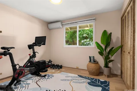 a living room with furniture a potted plant and a window