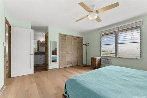 a bedroom with a bed and a large window