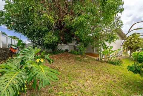 a view of a house with backyard and sitting area