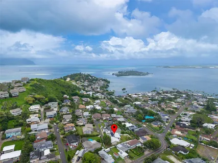 aerial view of a house with garden space and street view