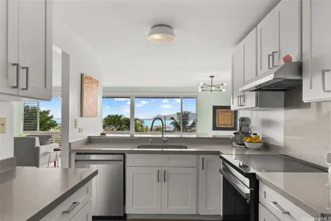 a kitchen with stainless steel appliances granite countertop a sink stove and cabinets