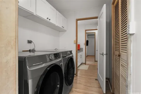 a view of a hallway with washer and dryer
