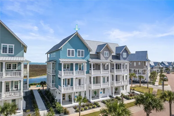 a front view of a residential apartment building with a yard