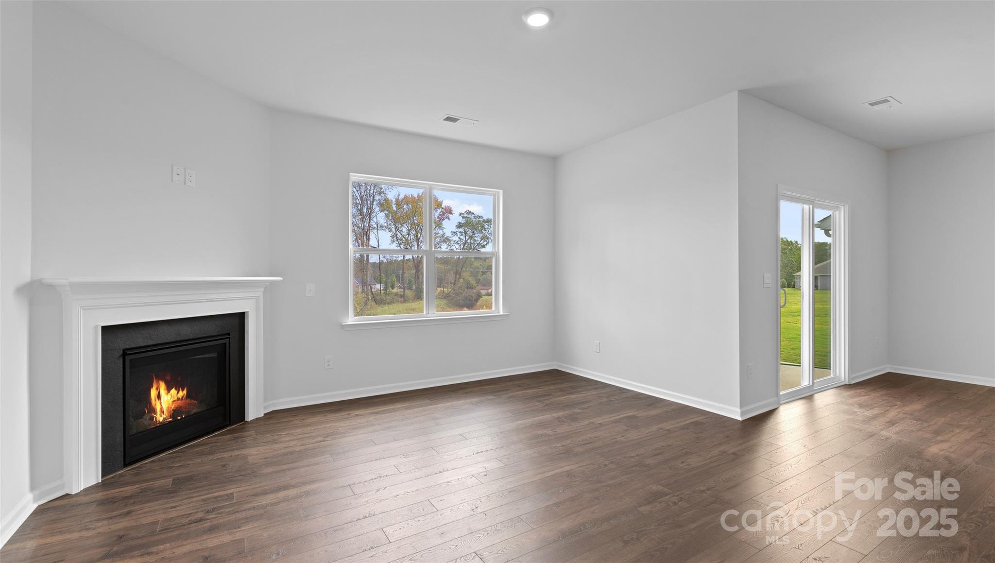 138 Bovine Br Road Fletcher, NC 28732 - Photo 7 of 20 a view of an empty room with wooden floor and a window
