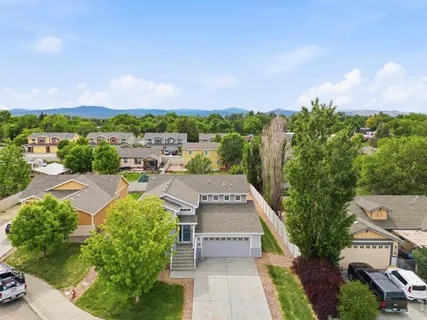 an aerial view of a house with a yard and lake view