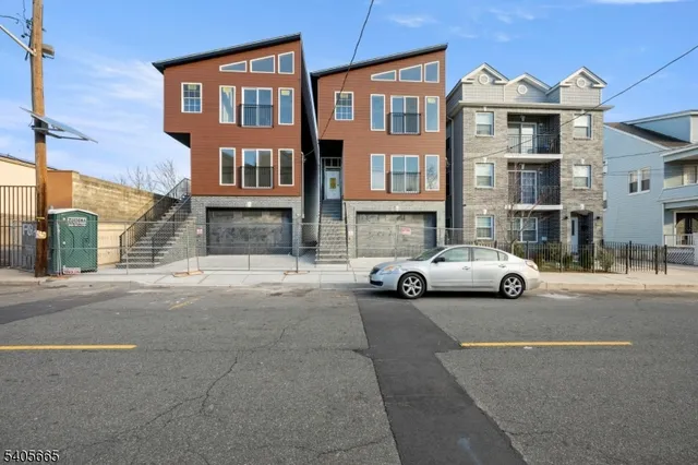 a view of a street that has couple of cars parked on the road