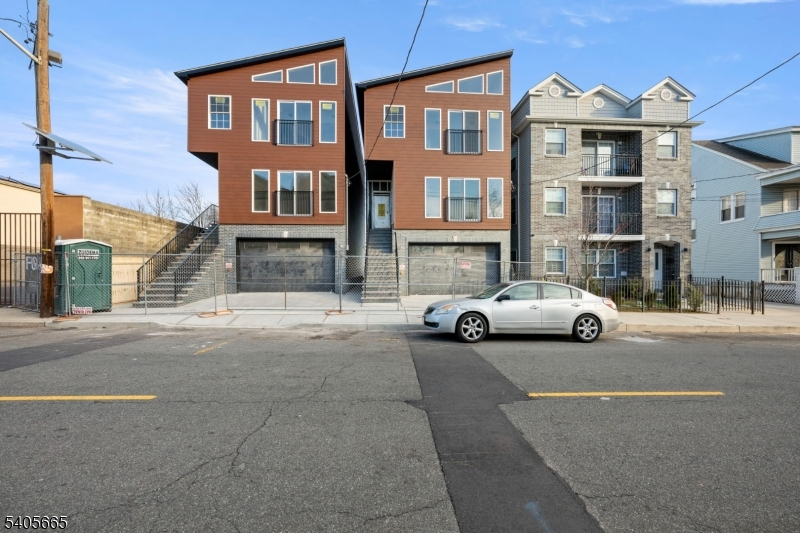 a view of a street that has couple of cars parked on the road