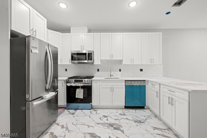 512 South 15th Street Newark, NJ 07103 - Photo 15 of 35 a kitchen with stainless steel appliances granite countertop a refrigerator sink and stove