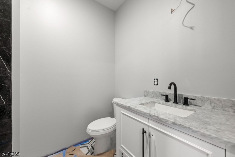 512 South 15th Street Newark, NJ 07103 - Photo 19 of 35 a bathroom with a granite countertop sink a toilet and mirror