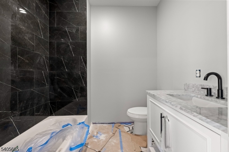 512 South 15th Street Newark, NJ 07103 - Photo 20 of 35 a bathroom with a sink toilet vanity and shower