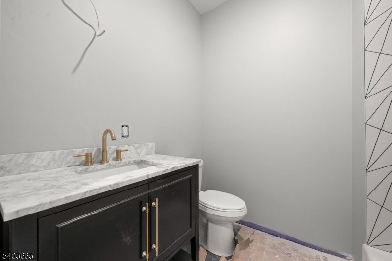 512 South 15th Street Newark, NJ 07103 - Photo 29 of 35 a bathroom with a granite countertop sink and a toilet