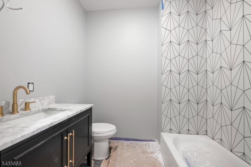 512 South 15th Street Newark, NJ 07103 - Photo 33 of 35 a bathroom with a granite countertop sink and a toilet
