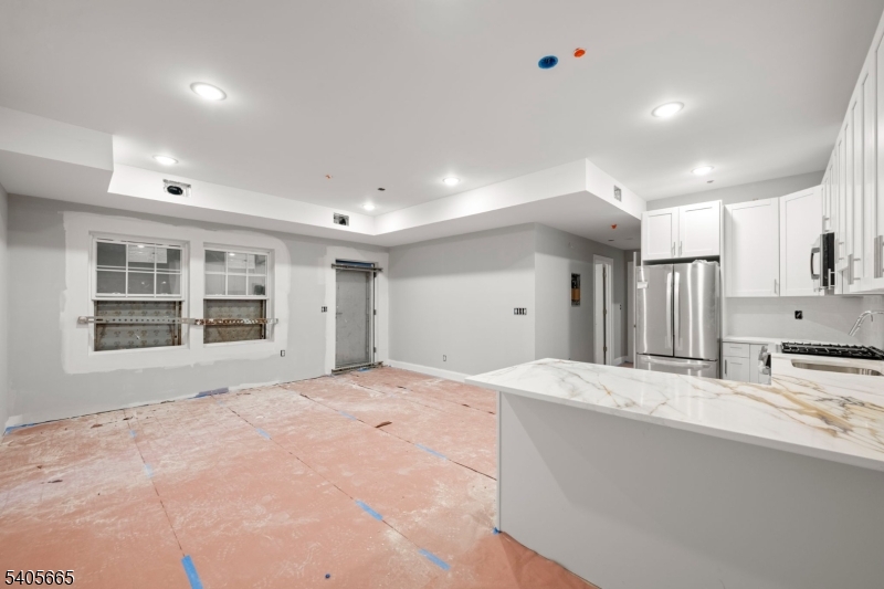 512 South 15th Street Newark, NJ 07103 - Photo 5 of 35 a large white kitchen with kitchen island granite countertop a sink and cabinets