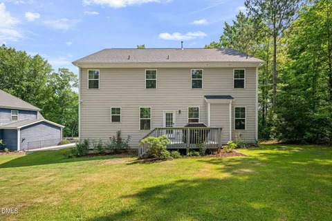 a view of a house with backyard and a garden