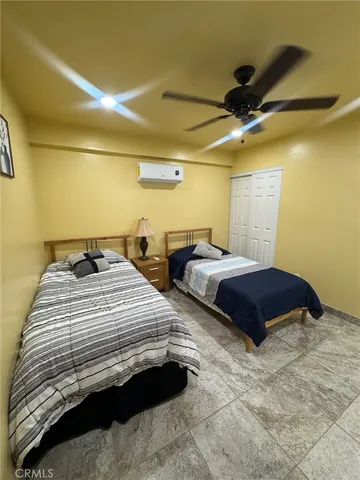 a bedroom with bed and a chandelier