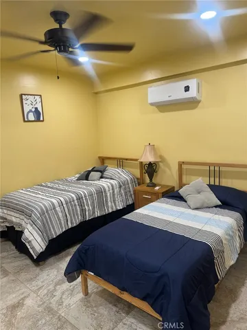 a bedroom with two beds and painted walls