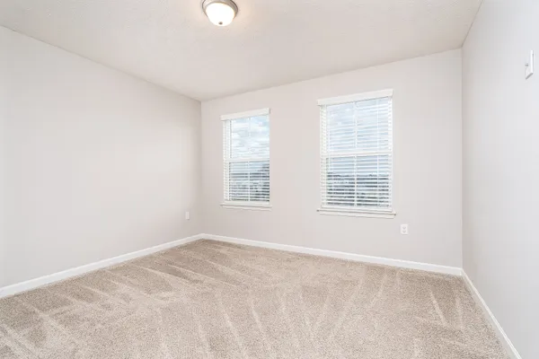 an empty room with closet area