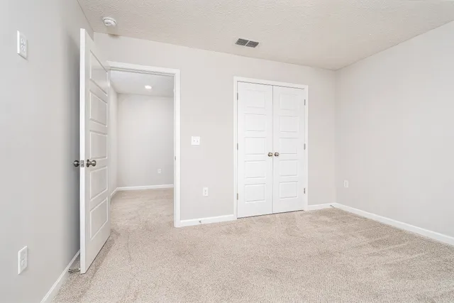 a bathroom with a granite countertop toilet a sink and a large mirror
