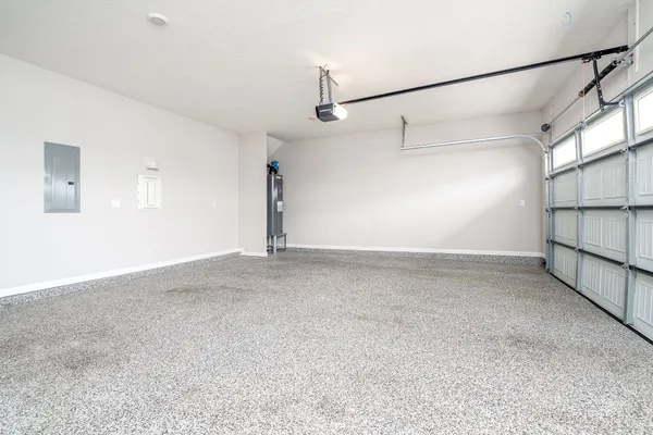 a view of a white house with a big yard and large trees