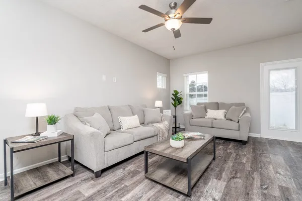 a living room with furniture and a chandelier
