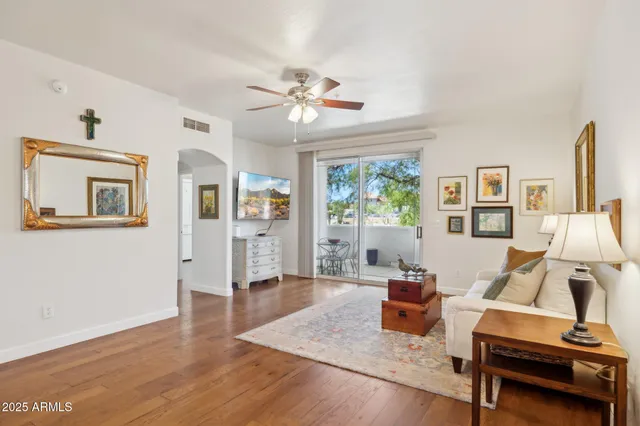 a living room with furniture and wooden floor