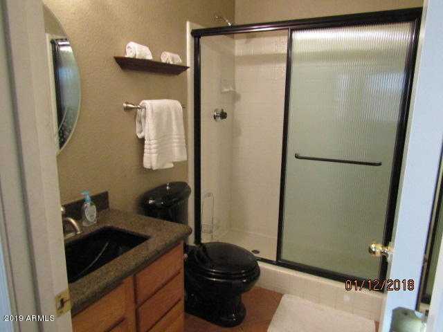 5808 East Brown Road, Unit 146 Mesa, AZ 85205 - Photo 7 of 10 a bathroom with a sink and a mirror