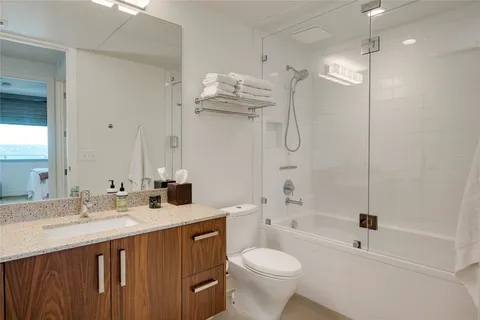 a bedroom with a bed and a lamp with the dresser