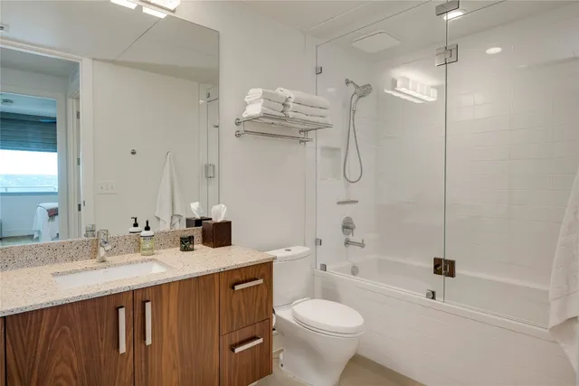 a bedroom with a bed and a lamp with the dresser